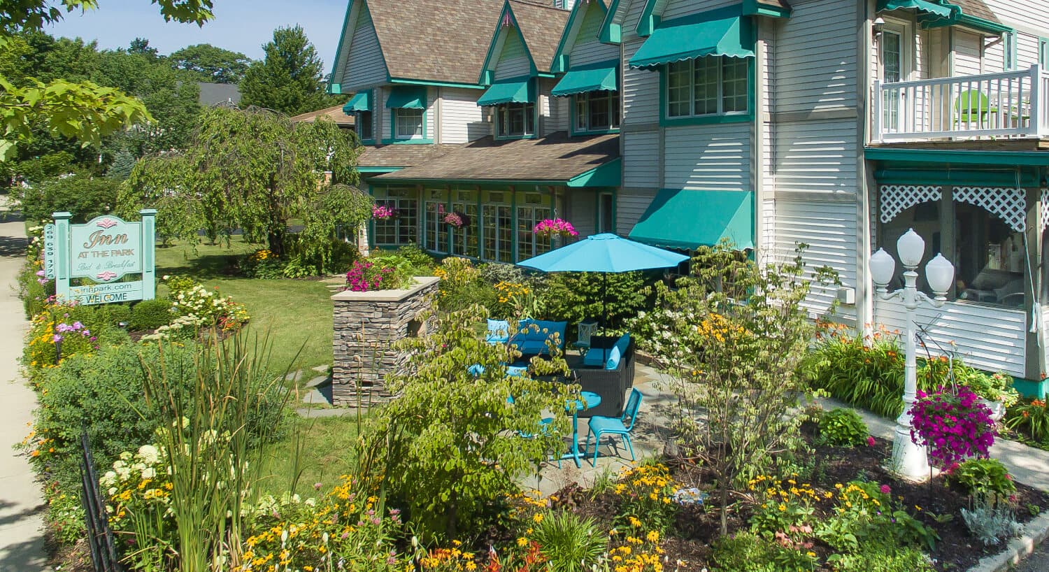 Charming bed and breakfast with blooming gardens and outdoor seating.