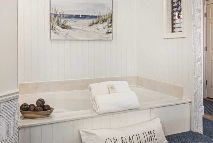 a soaking tub built into a nook in the bedroom