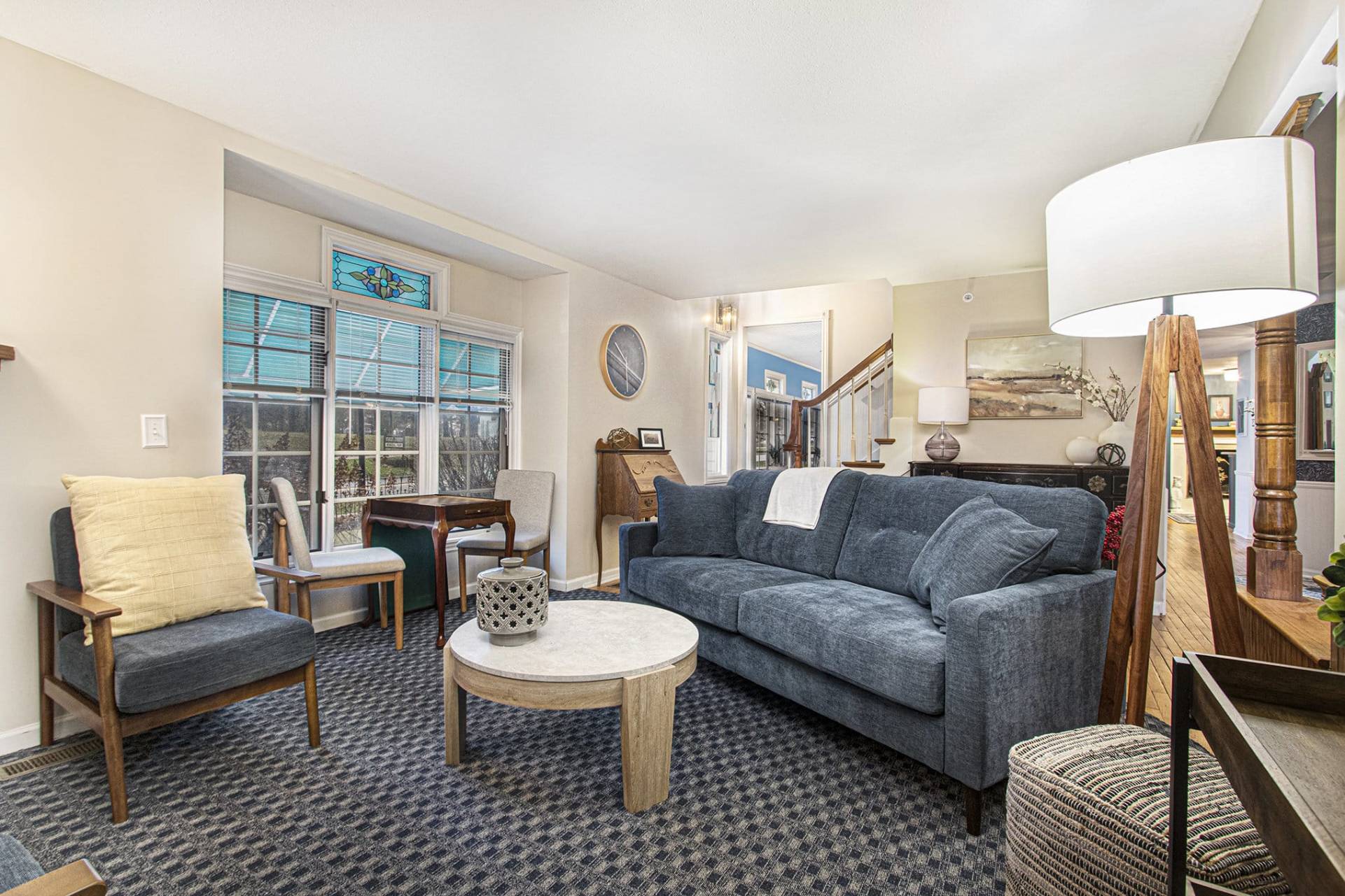 sitting room with blue couch, chairs, and a game table