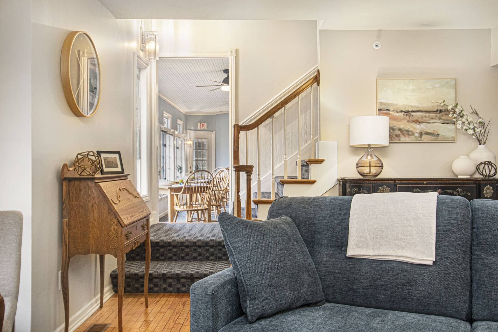 sitting room with blue couch, chairs, and a game table