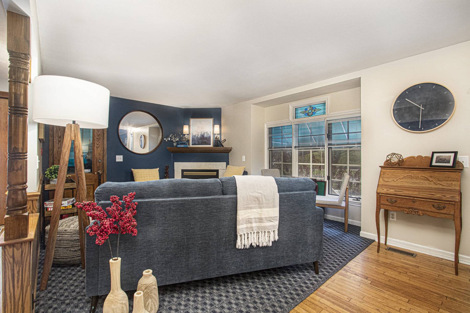 sitting room with blue couch, chairs, and a game table